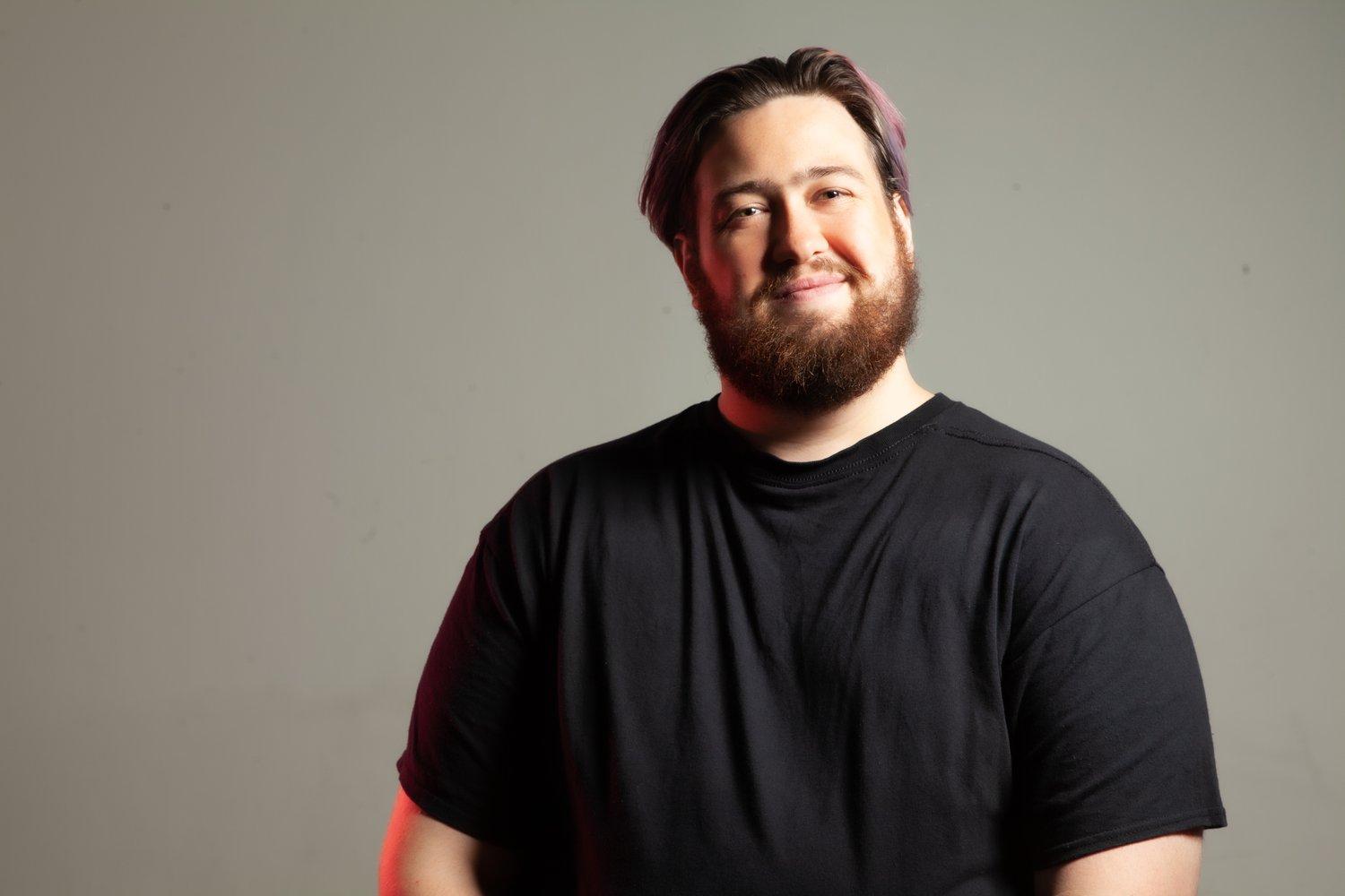 Matt stood in a black t-shirt against a white background.