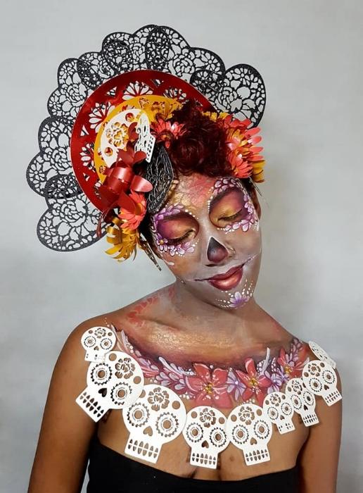 Rhyana dressed in black, white and red skull motif with matching make up against a white background.