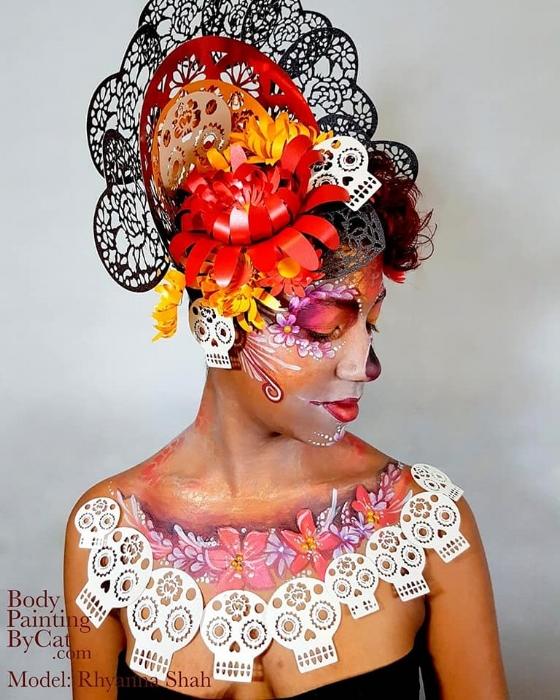 Close up of Rhyana dressed in black, white and red skull and flower motif.