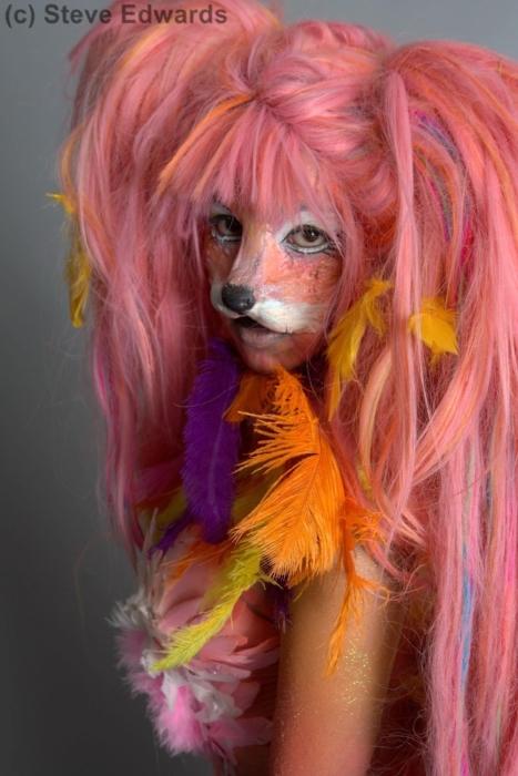Close up on Rhyana in a long-haired pink wig and fox make up.
