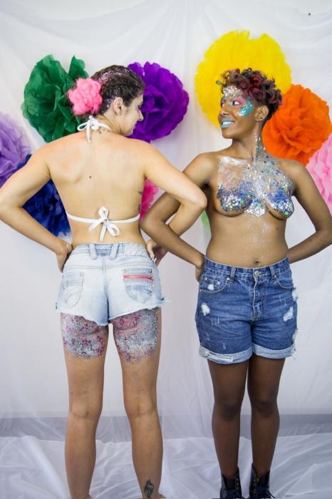 Rhyana posing with a fellow model in denim shorts and silver / blue body paint.