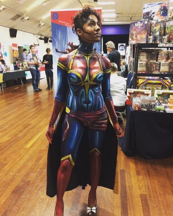 Rhyana posing in Ms. Marvel body paint with black cloak.
