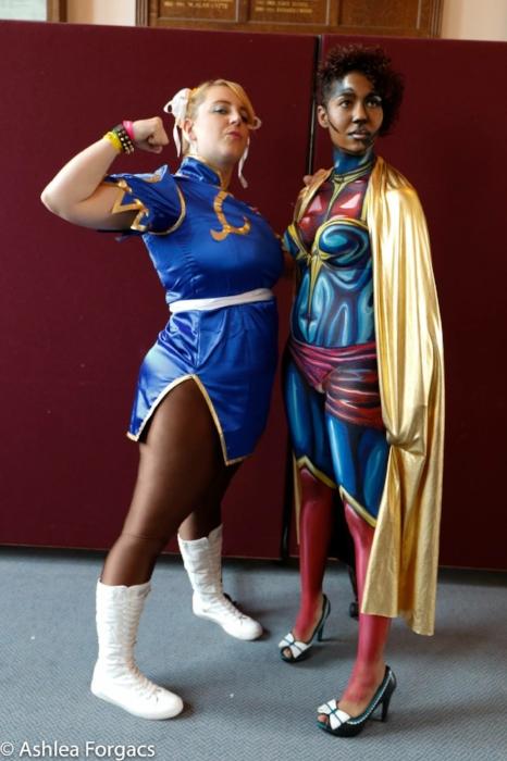 Rhyana in Ms. Marvel body paint, posing with fellow cosplayer Leigh Carter who is dressed as Sailor Moon.