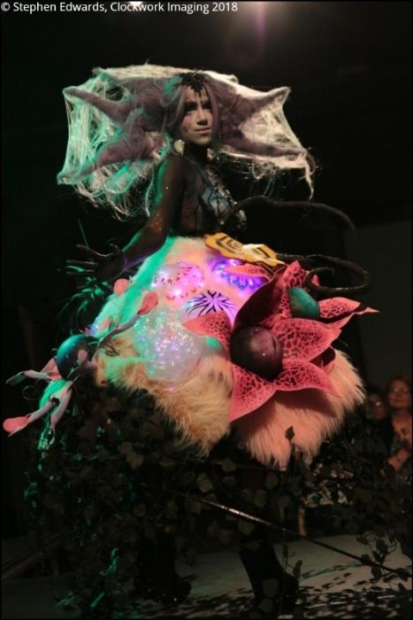 Rhyana in a forest-themed outfit with long claws.